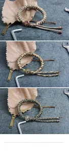 Macro detail of paracord bracelets with metal skull charms and tactical outdoor hardware