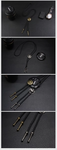 Detail of vintage bolo tie showing braided leather rope and engraved metal star buckle