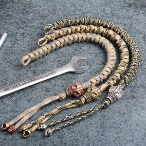 Tactical paracord keychains with metal skull beads in military green and khaki camouflage