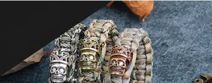 Detailed close-up of woven paracord bracelets with zircon-studded crown skull charms