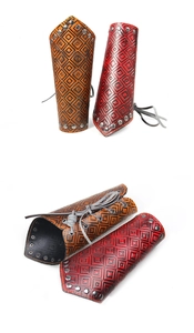 Macro shot of medieval style leather bracers with stud rivets and embossed patterns