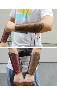 Detail view of retro leather bracers with geometric texture and metal rivet studs