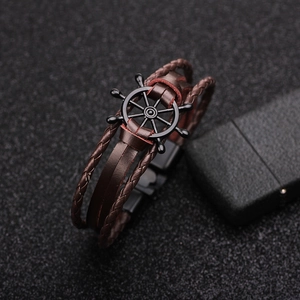 Brown multi-layer leather bracelet with black metal ship wheel charm and clasp buckle