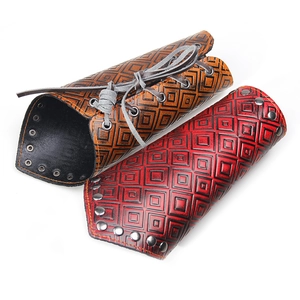 Vintage wide leather bracers with geometric check pattern and metal rivet details