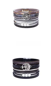 Detail of multi-layer leather bracelet with tree of life charm and magnetic buckle
