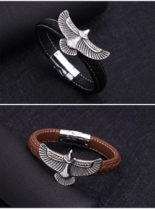Detail of men's leather bracelets featuring eagle charm and magnetic clasp