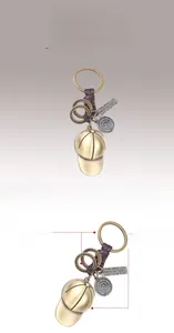 Detail of bronze baseball cap pendant with purple braided rope and engraved metal tag