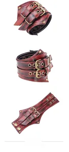 Macro detail of red and black punk leather bracelet with bronze studs and metal buckles