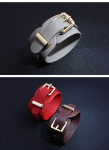 Detail of wide PU leather bracelets with Saffiano texture and gold metal buckles