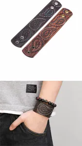 Detail eines breiten Vintage-Lederarmbands mit Paisley-Prägung und Metalldruckknöpfen