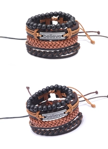 Detail of four-piece vintage men's leather bracelet set with 'Believe' metal charm