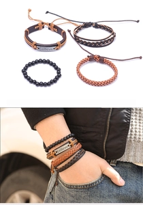 Detail view of a 4-piece set including leather braided bracelets and a 'believe' metal tag