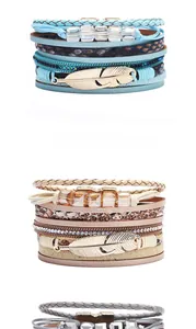 Detail of bohemian multilayer wrap bracelets with metal feather charms and stone beads