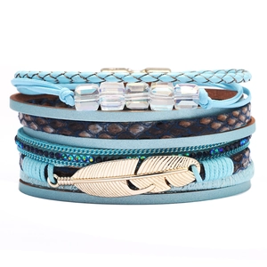Bohemian multilayer braided leather bracelet with blue tones and golden feather pendant