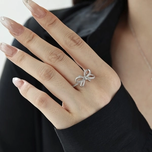 Elegant S925 sterling silver bow ring featuring micro-pave cubic zirconia stones on model