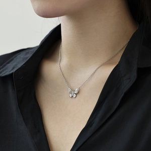 Detail of S925 sterling silver butterfly necklace with zircons worn on a model