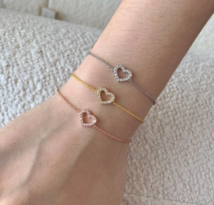 Detailed view of three minimalist s925 silver heart bracelets with pavé cubic zirconia