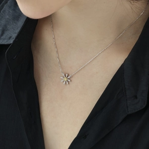 Exquisite S925 sterling silver daisy necklace with yellow zircon on a model's neck
