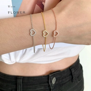 Three minimalist s925 silver heart bracelets in silver, gold and rose gold on a wrist