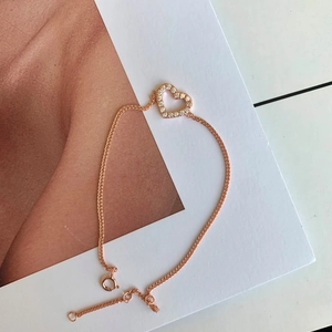 Detailed view of rose gold heart bracelet with sparkling pavé cubic zirconia inlay