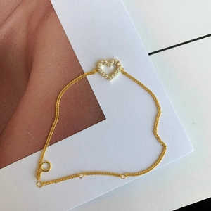 Macro view of rose gold hollow heart bracelet with shimmering cubic zirconia stones
