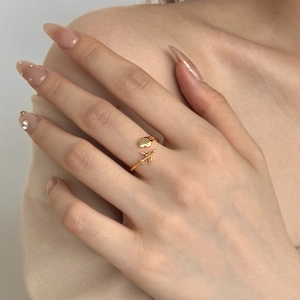 Close-up of golden S925 silver open ring featuring airplane and heart shaped charms