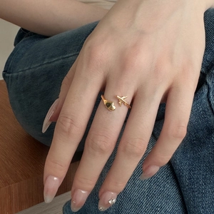 Minimalist S925 sterling silver open ring with gold airplane and heart charms on hand