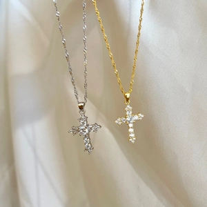 Close-up of S925 sterling silver cross pendant with sparkling zircon inlays on twisted chain