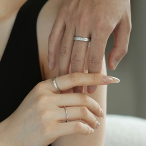 Detailed view of matte S925 silver couple rings with inlay stones on a hand