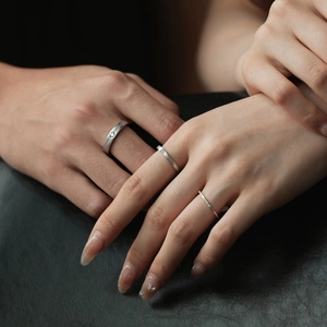 Macro shot of S925 sterling silver stacked rings with cubic zirconia on model hand