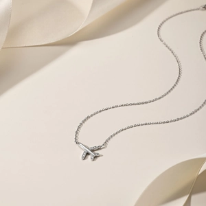 Detailed close-up of S925 silver airplane pendant with sparkling zircon micro-inlay
