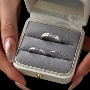 Detailed view of S925 sterling silver couple rings with matte finish and zircon inlays
