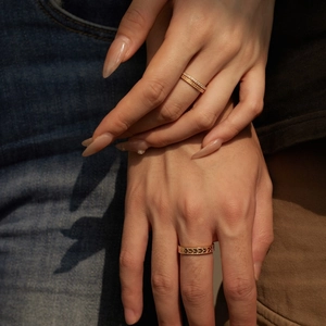 Close-up of S925 sterling silver couple rings set in rose gold finish with wheat pattern
