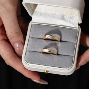 Close-up of matte S925 silver couple rings with diamonds in a velvet gift box