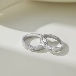 Macro shot of S925 sterling silver couple rings with matte finish and center zircon stone