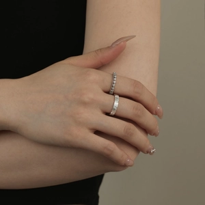 Detail of S925 sterling silver couple rings featuring pavé zircons and frosted texture finish