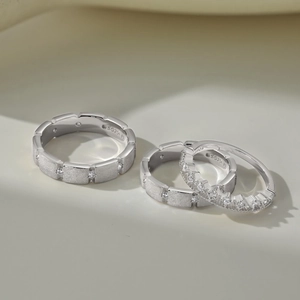 Close-up of S925 sterling silver rings with brushed finish and inlaid diamonds