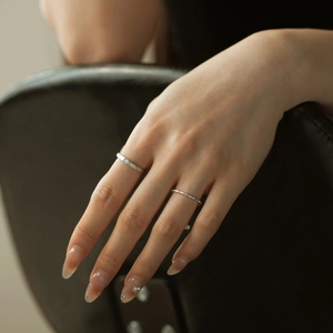 Close-up of elegant S925 sterling silver couple rings set with minimalist textures