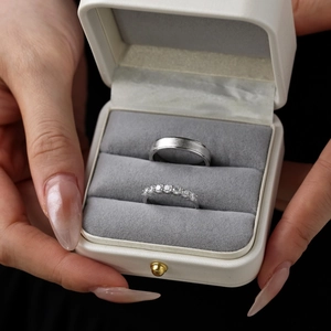 Close-up of S925 sterling silver couple rings set with matte finish and pavé diamonds