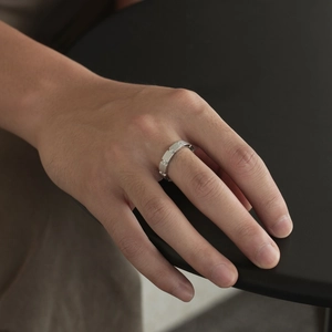 Detail of matte brushed S925 silver ring with small embedded diamonds on hand