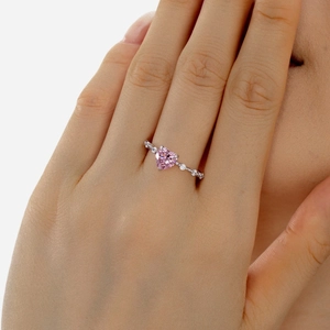 Close-up of S925 sterling silver ring with heart-cut pink zircon and side diamonds