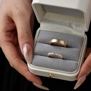 Close-up of S925 silver couple rings with matte finish and zircons in a jewelry box