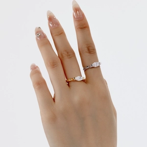 Marquise cut moissanite engagement rings in gold and silver finish on hand