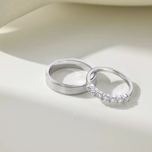 Macro shot of S925 sterling silver couple rings with matte finish and zircon inlay