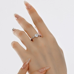 Close-up of S925 sterling silver ring with heart-shaped zircon on model hand