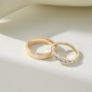 Macro shot of gold S925 sterling silver couple rings with matte finish and inlay stones