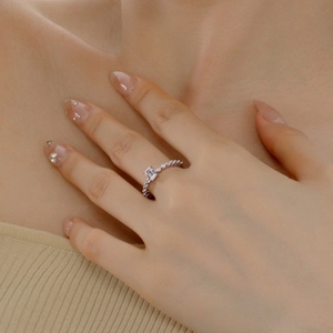 Macro detail of emerald-cut zircon silver ring with pavé stones on a model's hand
