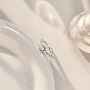S925 sterling silver ring featuring emerald cut cubic zirconia on a ceramic plate