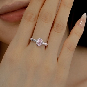 Close-up of S925 silver ring featuring an oval pink zircon stone on model finger