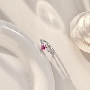 Detail of S925 sterling silver ring with pink heart-shaped stone and side zircons